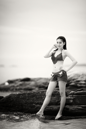 monotone shot of beautiful woman in bikini on the beach with shallow depth of field and vignette, focus on eyeの写真素材