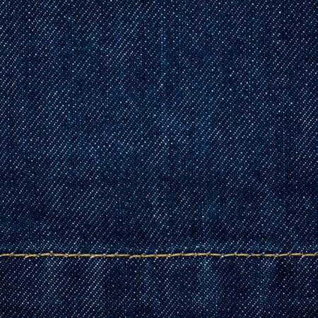 close up shot of raw denim dark wash indigo blue jeans texture background in square ratio