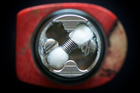 single micro coil with cotton wick in rebuildable dripping atomizer vape gear, vaporizer equipment, selective focus with shallow depth of fieldの写真素材