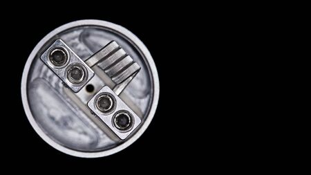 close up, macro shot, top view of single fused clapton coil in bottom feed squonk rebuildable dripping atomizer for flavour chaser isolated on black background, vaping device, selective focusの写真素材