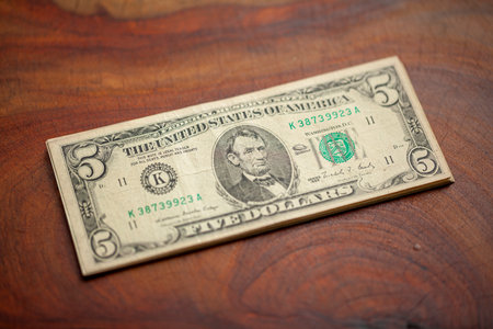 U.S. dollar, American dollar bank notes on natural  wood table texture background, selective focus...