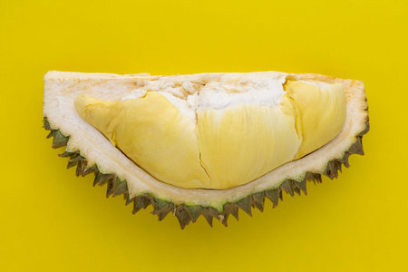 section of durian monthong flesh on yellow texture background, king of fruits