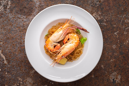 baked prawns with vermicelli, casseroled shrimps with glass noodles in white simply ceramic plate on...
