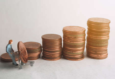 A man's doll is collecting coins for collection (Coins Thailand), business conceptの写真素材