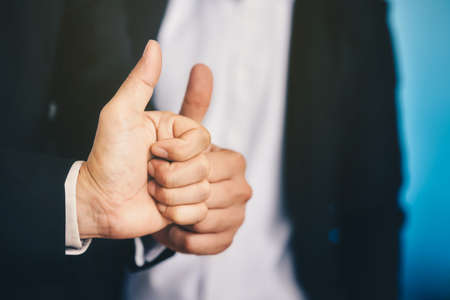 Businessman is lifting thumbs To display indescribably and agree to terms in business.の写真素材