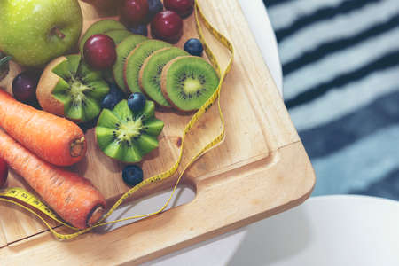 A yellow measuring tape surrounds the fruit.Health Care and Weight Management Conceptsの写真素材
