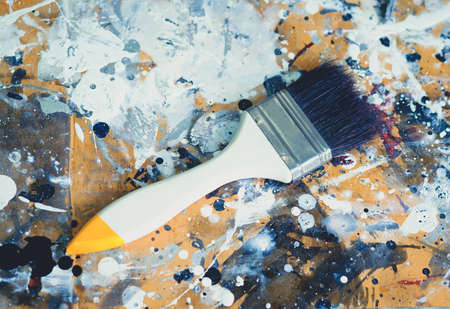 Paint brushes and paint on a vintage background abstract art.の写真素材