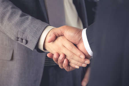 businessmen are handshake agree to join the business.On a white background .Focus at handの写真素材