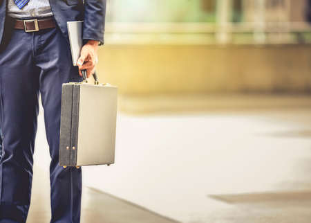 A businessman carrying a briefcase goes to work in his daily routine with determination and confidence.の写真素材
