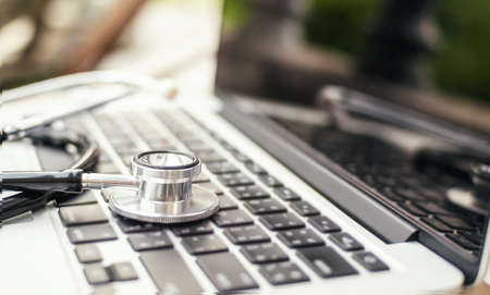 The doctor's earphones with laptops are checking and checking for malfunction.の写真素材