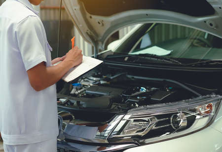 Check the details of the vehicle in order to repair.Detail of lifted automobile at repair service stationの写真素材