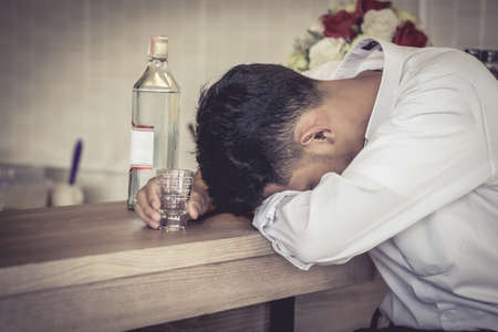 Men sit back, sleep at the bar, and get drunk because of disappointment in life.の写真素材