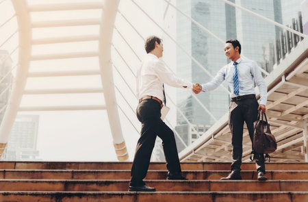 Businessmen are handshake to agree to join the business. The same team in the big city.の写真素材