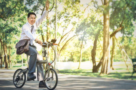 Asian business people use their bicycles to travel to work every morning.の写真素材