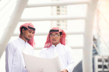 Arab businessmen and architects are discussing plans for major cities.の写真素材