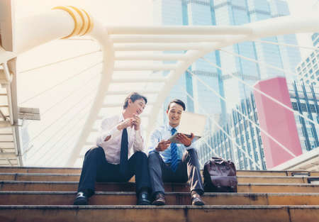 Asian businessmen are discussing joint business meetings in the city.の写真素材