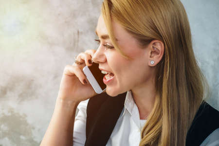 Business woman talking on the phone with a smartphone.の写真素材