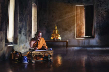 The monk is studying Buddhist activities.の写真素材