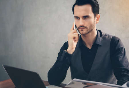 Businessmen are using smartphones to contact business people for success.の写真素材