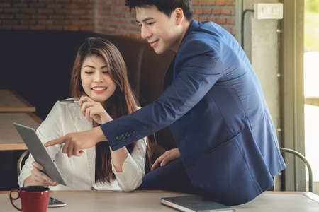 Female secretary and businessman Asians are looking at information to plan their work for stability and sustainability.の写真素材