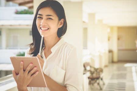 Asian women businessmen use tablet to contact work and business.の写真素材
