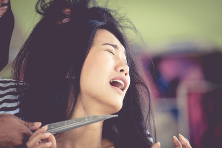 Thieves used a knife to threaten a woman held hostage.