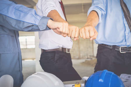 Architects, engineers and businessmen are fisting together. To work together as a team to work successfully.の写真素材