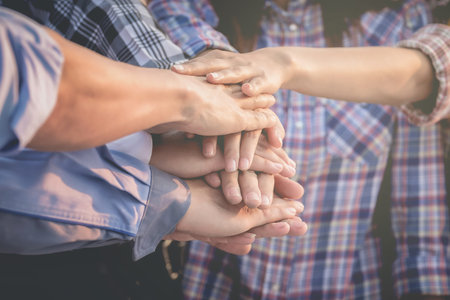 Business people and architects join hands for teamwork and unity and sustainability.