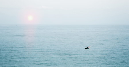 A small fishing boat floating in the beautiful sea.
