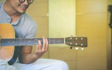 Young man is relaxing with his guitar.の写真素材
