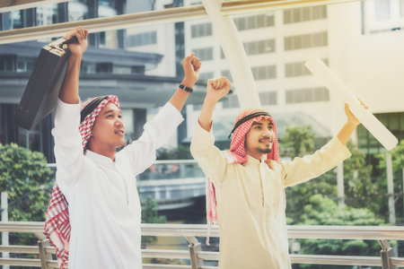 A group of Arab businessmen raised their fists to ensure success in their destination.Business...