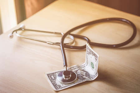 Doctor's headphones are on the dollar. Concept money can not buy good health.の写真素材