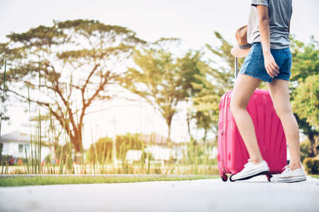 Teenage girls with pink luggage and prepare to travel on vacations.This image is motion blur.の写真素材