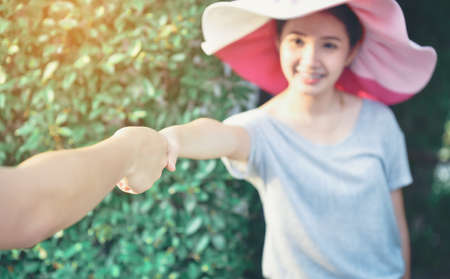 The man and the woman are holding hands together for a holiday.の写真素材