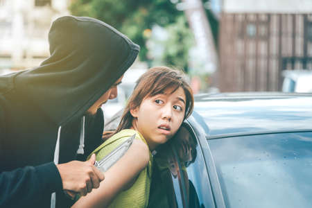 Asian women are being mugged, robbed of cars and property. Self-Defense Conceptの写真素材