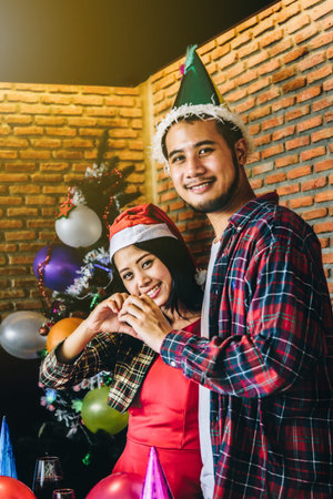 Asian young people enjoy Christmas parties on their holidays.の写真素材