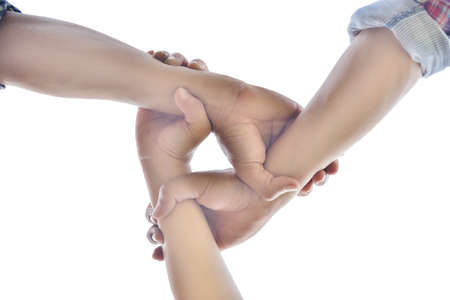 Business partners join hands together. Teamwork and unity are one and the same.on white background isolated.の写真素材