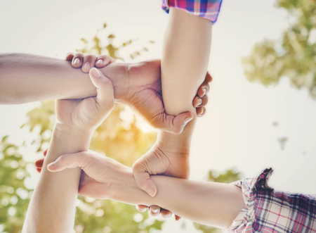 Business partners join hands together. Teamwork and unity are one and the same.