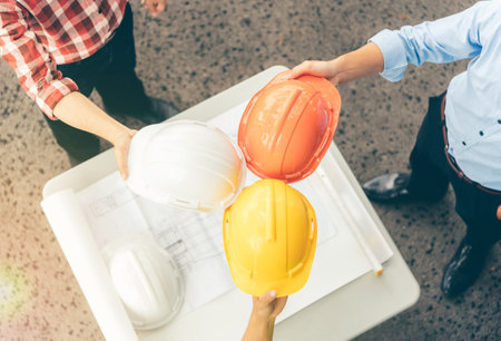 Architects and engineers took a helmet touching each other to show power.To work together as a team...