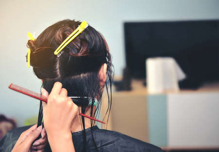 One Asian lady is curling, hairdressing by a hairdresser.の写真素材