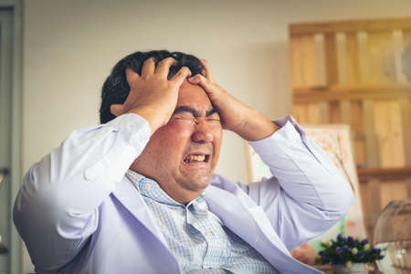 The middle man aged people are shown, headaches and stress greatly.の写真素材