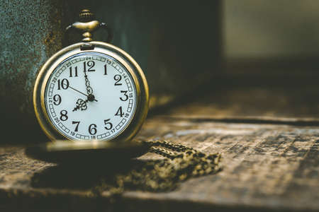 The old clock necklace on woodenの写真素材