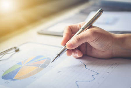 Hand of a businessman holding a pen is analyzing, business planner.For profit and stability of business sustainability.の写真素材