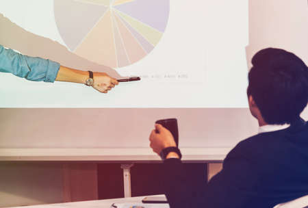 An Asian businessman was presenting the meeting, explaining and introducing participants to the meeting.の写真素材