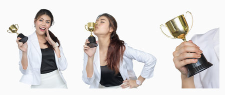 Set asian businesswoman is delighted with her accomplishments, is kissing the trophy she receives....