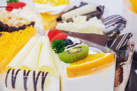 Fresh milk cakes and a variety of fruits that are beautifully decorated, look attractive.の写真素材