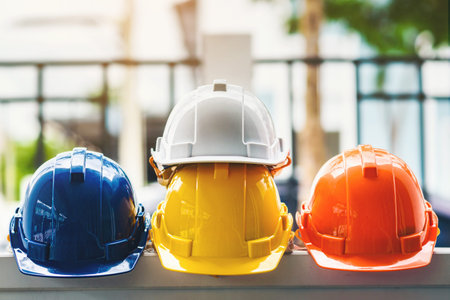 White, yellow and other colored safety helmets for workers' safety projects in the position of...