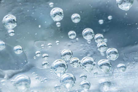 The soda bubbles in a glass of water that is distributed beautifully.