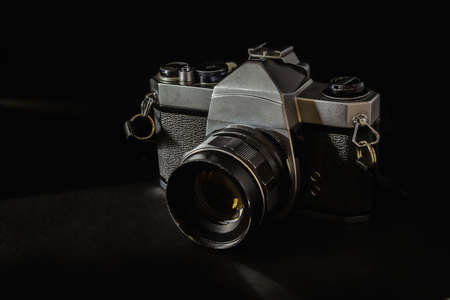 Old vintage camera that has been used for a long time on a black background.の写真素材