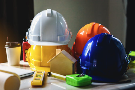 White, yellow and blue safety helmets for workers' safety projects in the position of engineers and...